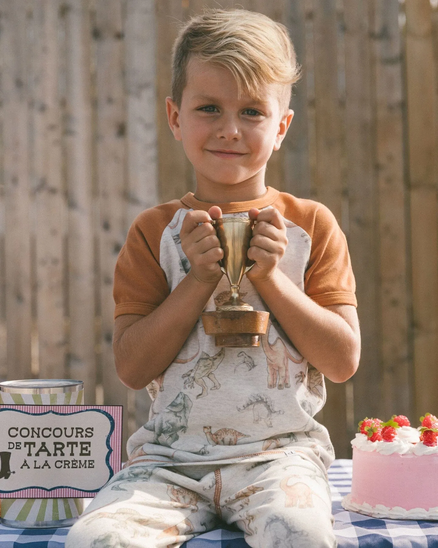 Organic Cotton Two-Piece Short Sleeve Top And Pant Pajama Set Dinosaur On Mottled And Tan Background