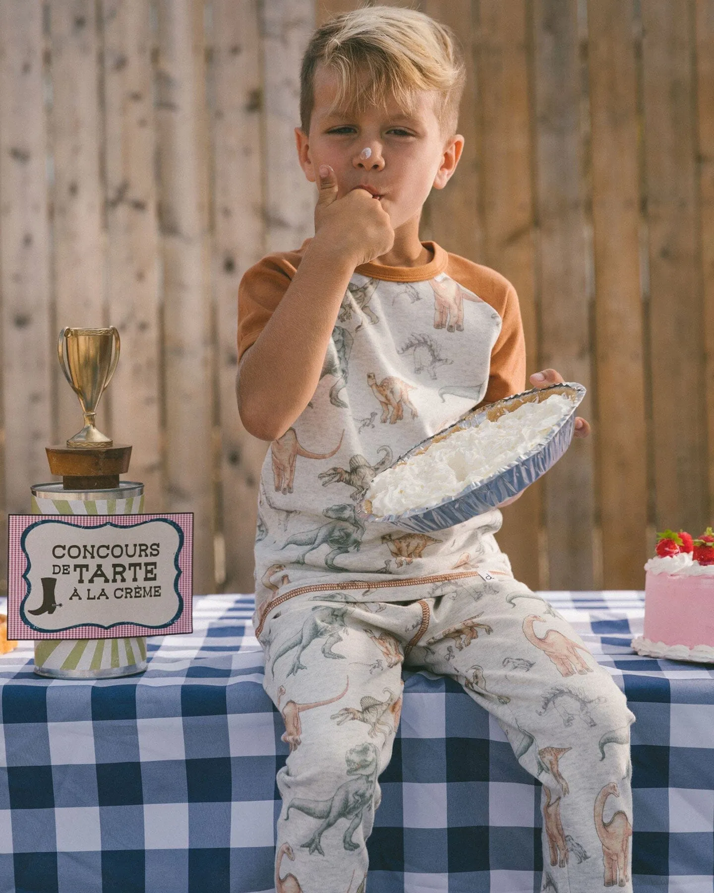 Organic Cotton Two-Piece Short Sleeve Top And Pant Pajama Set Dinosaur On Mottled And Tan Background